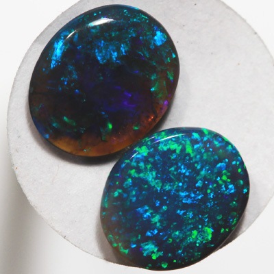 SOLID BLACK OPALS Matching pair. Bright green sparkles constantly